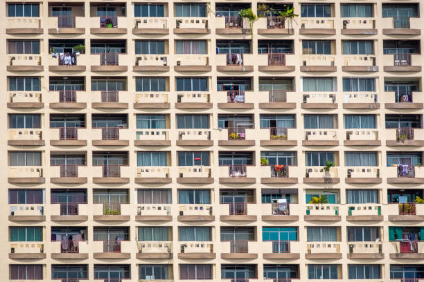 istock Front view of apartment building background. The windows office building for background. Condominium or apartment building with asymmetrical, stair-step architecture in the Bangkok city 1153838432