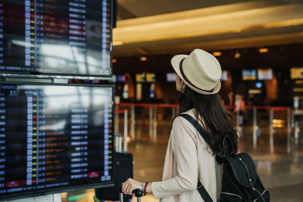 istock traveler looking on schedule waiting in lobby 1153838472