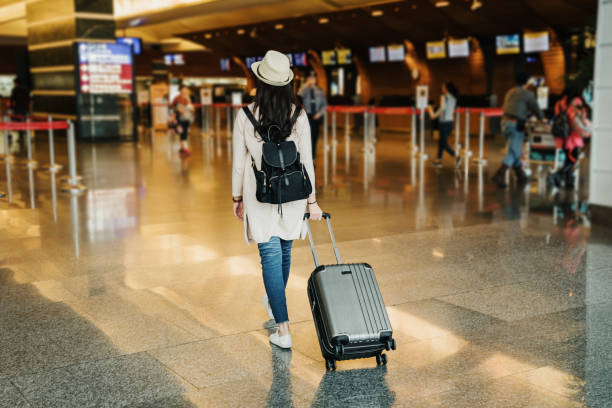 istock asian businesswoman drag suitcase walking 1153838536