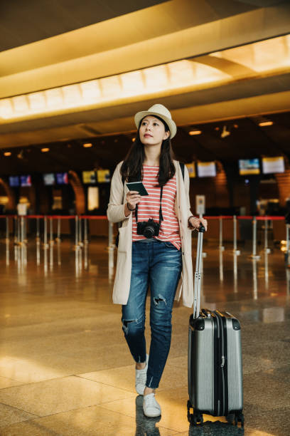 istock woman waiting for flight at airport terminal 1153838587