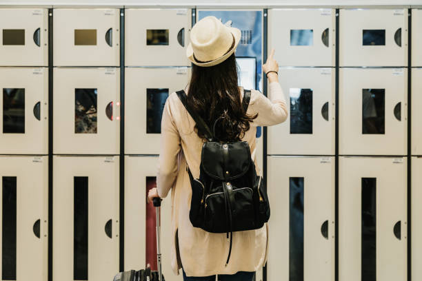 istock back view of female backpacker uses safety locker 1153839416