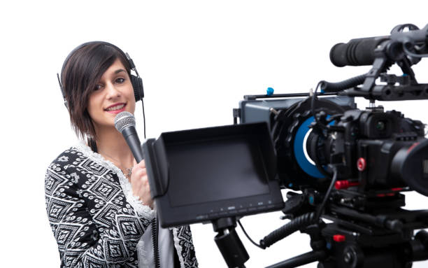 istock pretty young woman  journalist with microphone and camera on white 1153839588