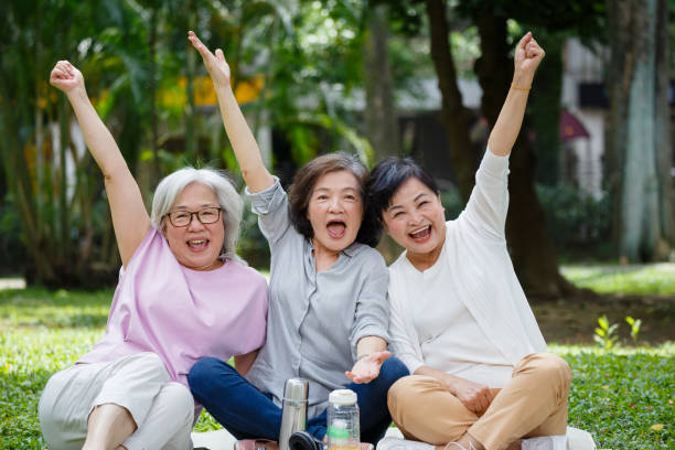 istock senior women get together having fun in the park 1153839652