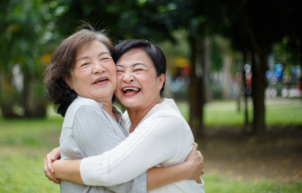istock Two senior women hugging each other 1153839803