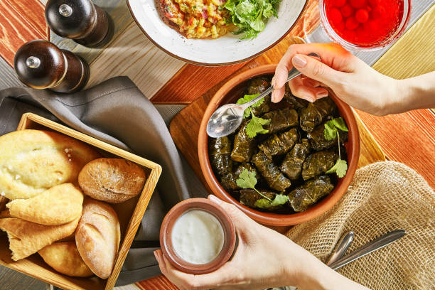 istock Traditional Turkish Dolma and Hand with Spoon Top View 1153844134