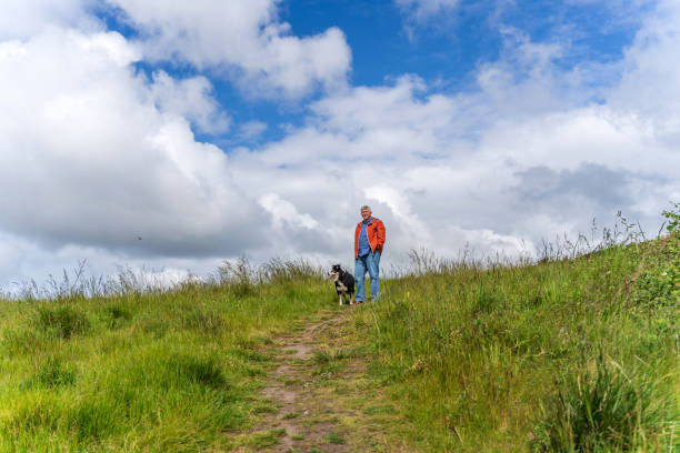 istock Active senior man and dog in countryside 1153845776