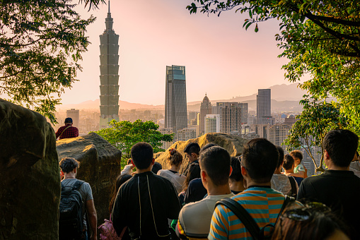 People gathering on Elephant Mountain in Taipei, to witness the sun setting over the city's skyline.