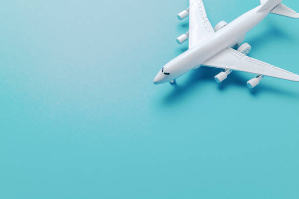 istock jet airplane travel concept, minimal art, on soft blue background. 1153846924
