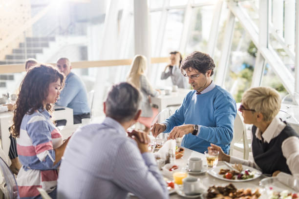 istock Large group of business people having lunch break in cafeteria. 1153847048