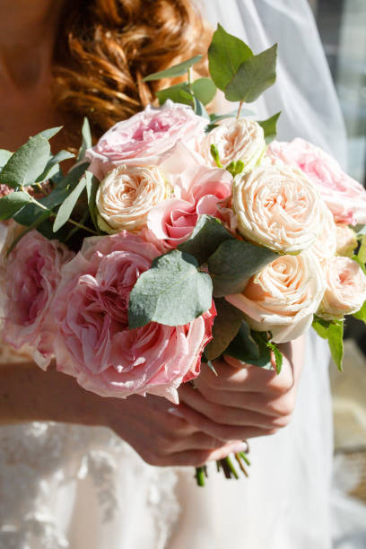 istock Beautiful wedding rustic bouquet with white roses and eustoma 1153847100