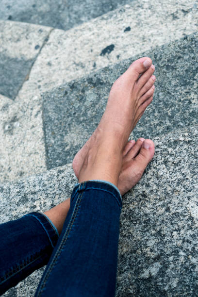 istock man resting barefoot on the street 1153847107