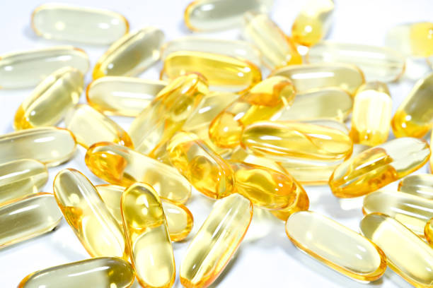 istock Fish oil capsule on isolated white background. 1153848625