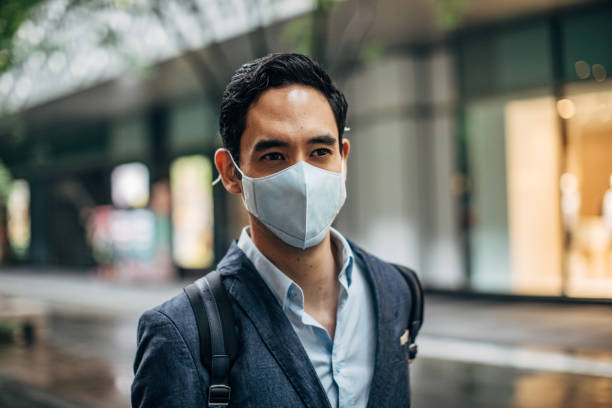 istock Gentleman with pollution mask in city 1153849977