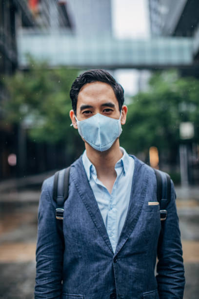 istock Gentleman with pollution mask downtown 1153850591