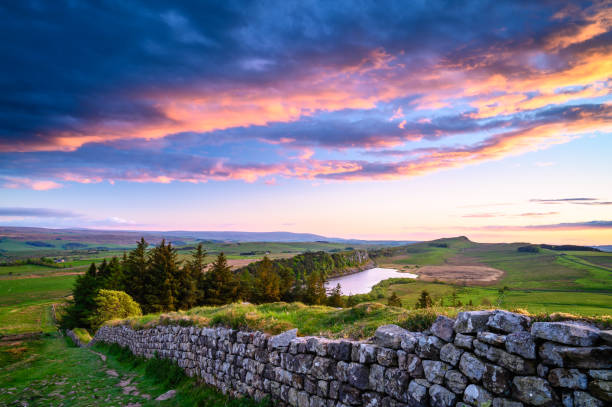 Crag Lough and Hadrian's Wall at Sunset Hadrian's Wall is a UNESCO World Heritage Site in the beautiful Northumberland National Park. popular with walkers along the Hadrian's Wall Path and Pennine Way pennines photos stock pictures, royalty-free photos & images