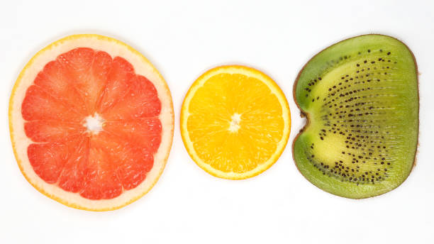 istock across sliced kiwi, orange and grapefruit on white background 1153852083