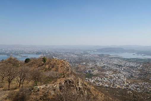 Stock photo of the view from the Monsoon Palace (Sajjan Garh Palace) on the Bansdara peak, part of the Aravalli Mountain Range, Udaipur, Rajasthan, India. In the distance Fateh Sagar Lake and Pichola Lake can be seen.