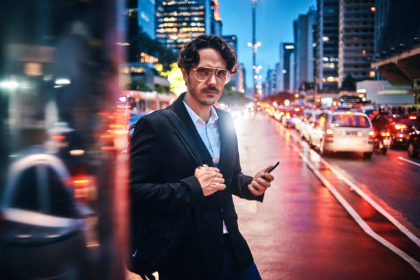istock handsome businessman using his smartphone in the city 1153852511