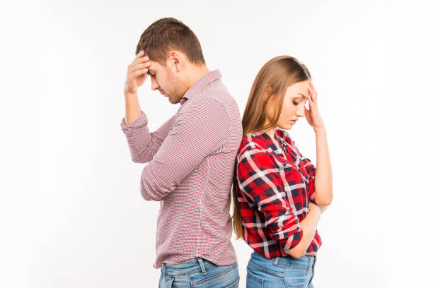 istock Couple in love standing back to back ignoring each other 1153854761