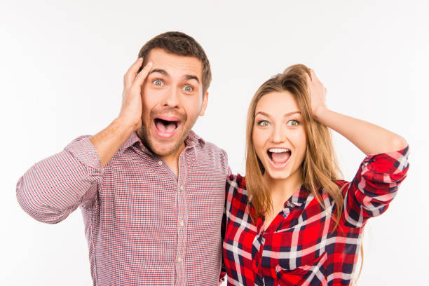 istock Funny cheerful couple showing surprise 1153854987