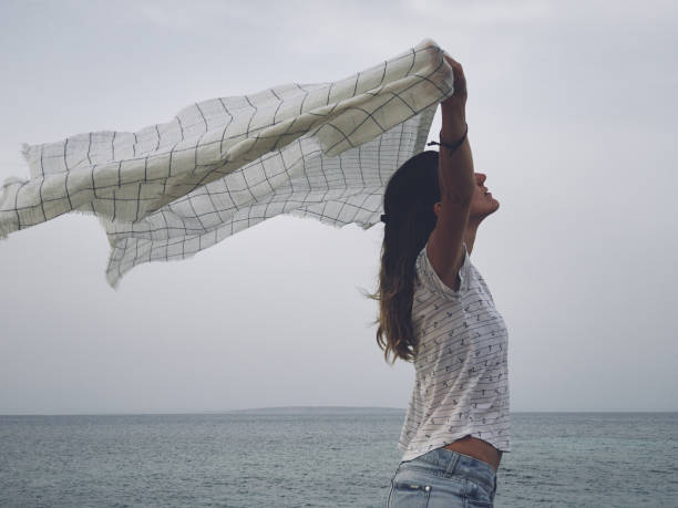 istock With arms wide open on a tropical / ocean scenery. 1153854989