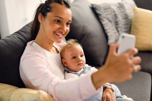 istock Happy mother taking selfie with her baby boy. 1153855472