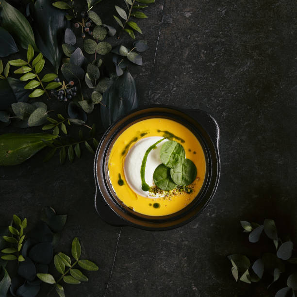 exquisite serving pumpkin cream soup with ricotta cheese mousse top view - hot couture imagens e fotografias de stock