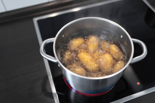istock pot with boiling water and potatoes on stove 1153858391
