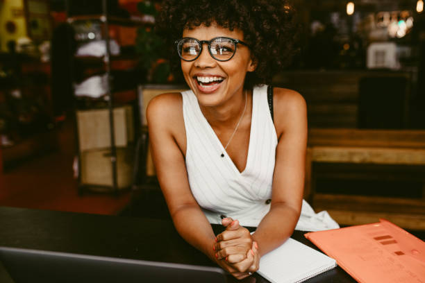 istock Smiling woman sitting in the cafe 1153859490