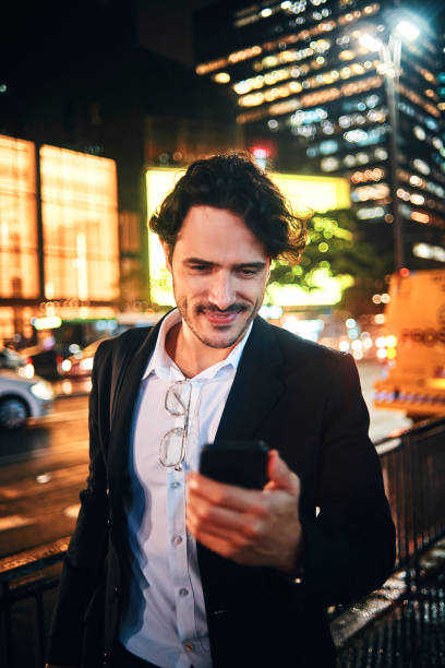 istock handsome businessman using his smartphone in the city 1153859758