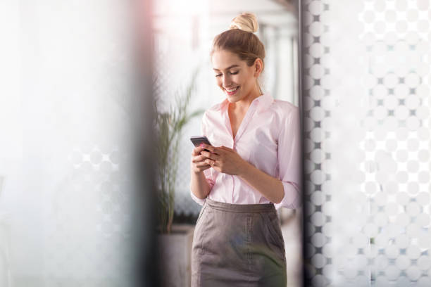 istock Business woman using smartphone in office 1153860723