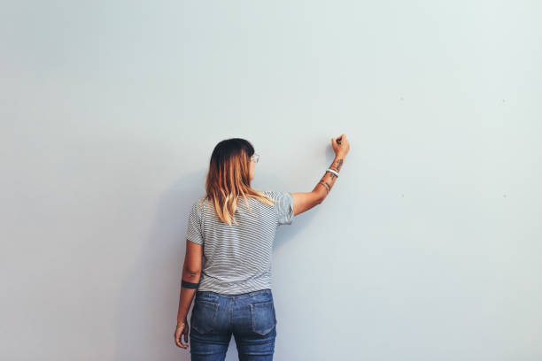 istock Woman drawing on a wall 1153860789