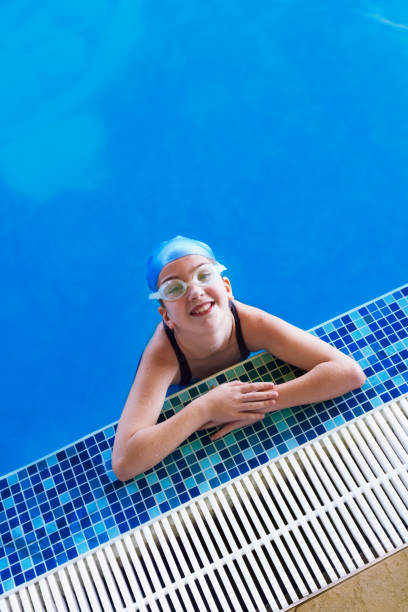 Young beautiful girl having fun in the swimming pool