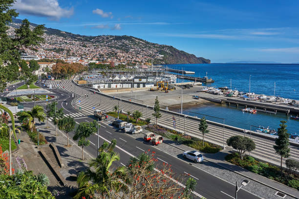 Wood Funchal, Portugal - December 20, 2018: Pedestrians and traffic in the bay of Funchal in winter just before Christmas. praia da marinha stock pictures, royalty-free photos & images