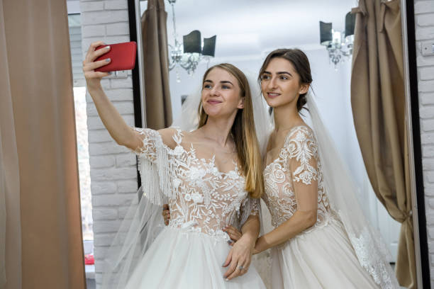 istock Young friends in wedding salon making selfie 1153862276