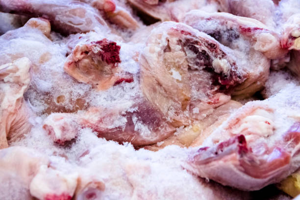 istock Frozen raw chicken, background macro view from above 1153862677