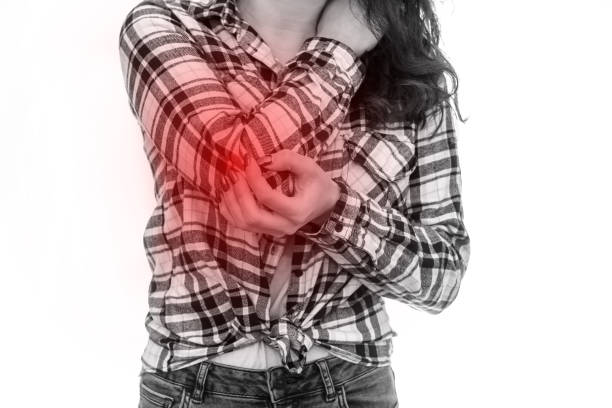 istock Woman holding her elbow isolated on white 1153862858