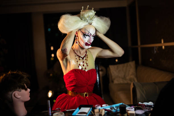 istock Man drag queen putting blond wig 1153862916