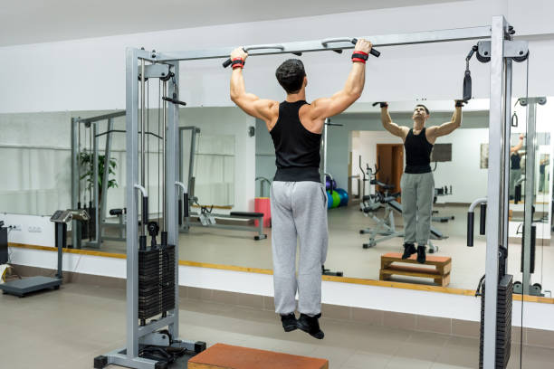 istock Young and athletic man doing exercises on crossbar 1153863967
