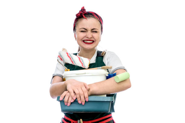 istock Happy woman with painting tools isolated on white 1153864006