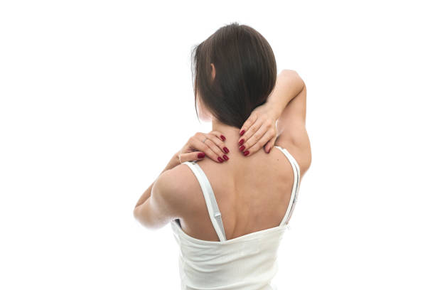 Woman massaging back pain on white background.  “Image is not body shape retouched”