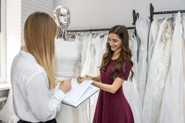 istock Young designers working at wedding dress in salon 1153864772