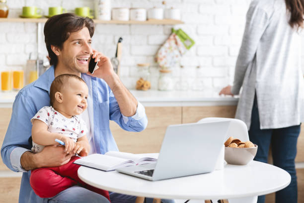 istock Father Working From Home On Laptop With Baby Son 1153867127
