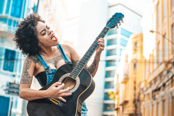istock Punk woman playing acoustic guitar 1153869459