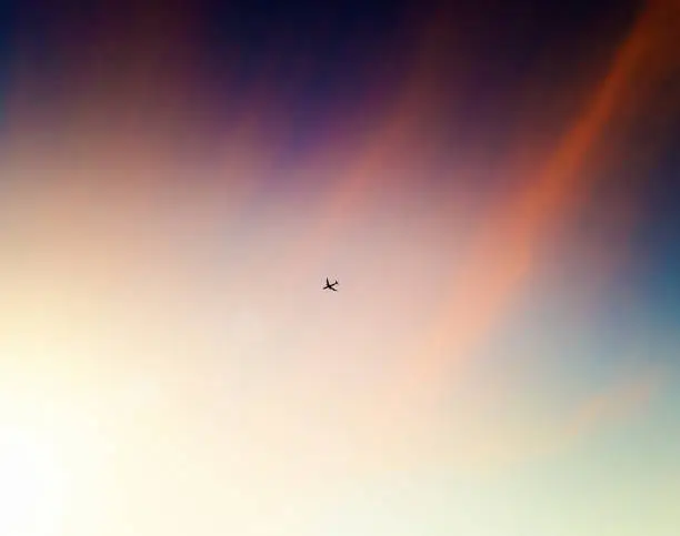 Passenger aircraft heading towards the sun.