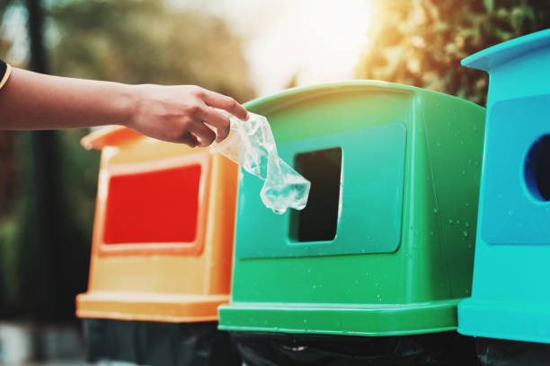 istock people hand holding garbage bottle plastic putting into recycle bin for cleaning 1153872547