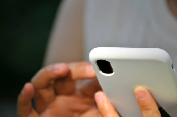 Woman hand using a mobile phone outdoors