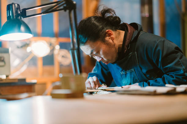 istock Asian man making craft from wood 1153872728