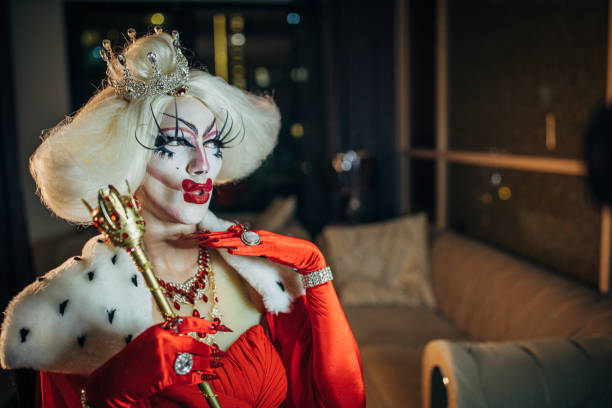 istock Drag queen holding a golden scepter 1153875072