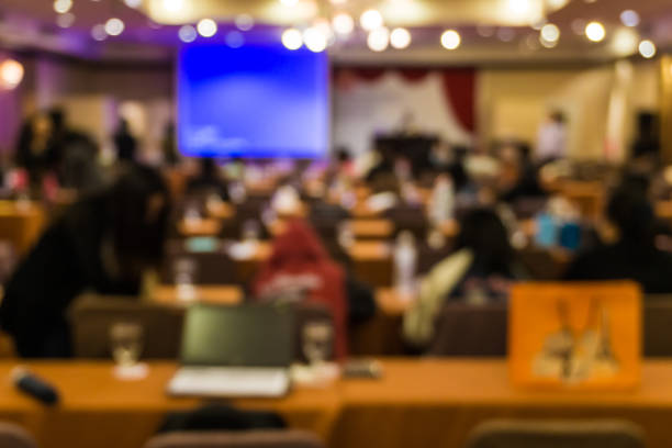 istock Blurred people meeting in seminar room 1153879626